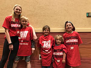 children posing in jett t-shirts