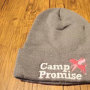 Camp Promise gray knit hat with Camp Promise logo in white text and pink pigasus logo on the front