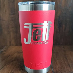 Red yeti tumbler with the Jett Foundation logo in silver