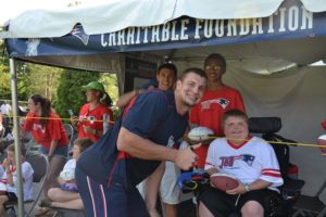 rob gronkowski posing with group of children