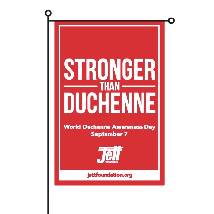 Red garden flag with white text that says Stronger than Duchenne at the top in large text.  Below in smaller white text it says World Duchenne Awareness Day September 7.  The Jett logo is below all the text and at the very bottom of the flag in red text with a white background is the website address