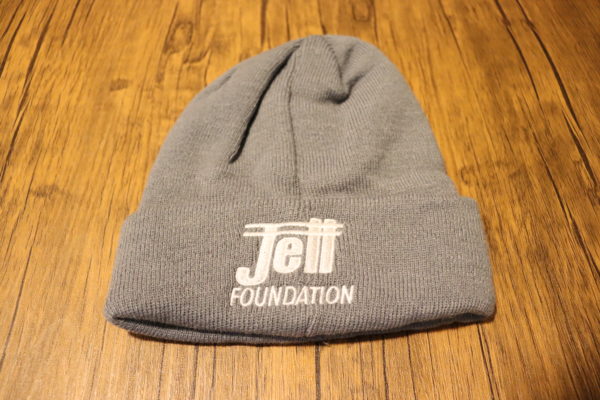 Jett Foundation gray knit hat with Jett logo in white text on the front