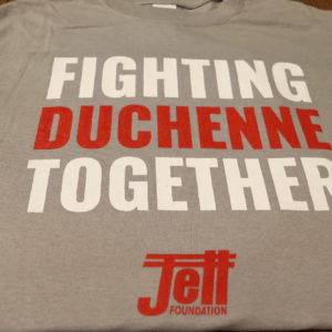 Heather Gray t-shirt with fighting Duchenne together text on front, fighting written in white text, duchenne written in red text and together written in white text with the Jett logo in red at the bottom