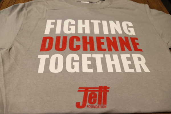 Heather Gray t-shirt with fighting Duchenne together text on front, fighting written in white text, duchenne written in red text and together written in white text with the Jett logo in red at the bottom